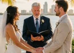 Florida wedding officiant leading a Christian waterfront wedding ceremony as a bride and groom exchange vows beneath palm trees during a sunset celebration.