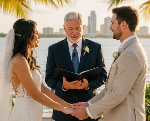 Florida wedding officiant leading a Christian waterfront wedding ceremony as a bride and groom exchange vows beneath palm trees during a sunset celebration.