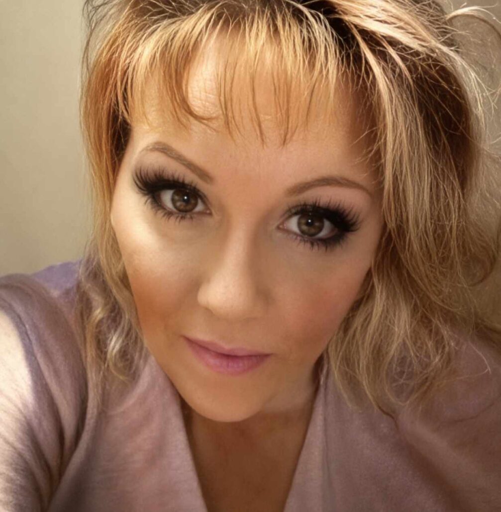 Portrait of Kristie Hagmeier from Anchorage, Alaska, smiling softly in a close-up photograph.