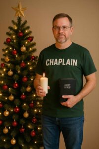 Casual Christmas Chaplain in t-shirt and jeans holding a Bible and candle beside a decorated Christmas tree, symbolizing prayer and ministry during the holiday season.
