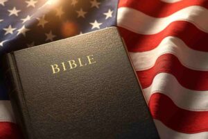 Holy Bible resting on the American flag symbolizing Christian faith, biblical values, and spiritual heritage in the United States