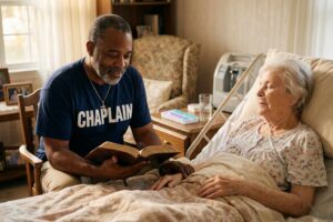 Male hospice chaplain praying with hospice patient in peaceful home care environment