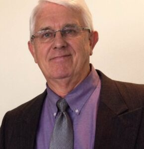 Rev. William K. Posey III smiling in formal attire, a Christian ministry chaplain candidate with a background in military service, education, and community ministry