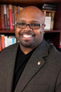 Sports chaplain candidate, Army veteran and former NYPD detective, standing confidently while serving athletes through coaching, mentorship, and Christian spiritual leadership.