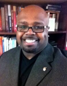 Sports chaplain candidate, Army veteran and former NYPD detective, standing confidently while serving athletes through coaching, mentorship, and Christian spiritual leadership.