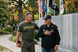 Veterans chaplain walking with military veteran at memorial wall providing pastoral care and spiritual support