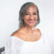 Professional headshot of Christian life coach minister Cynthia smiling in a white blouse against a light background.