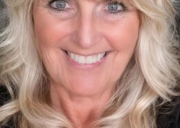 Portrait of Christian life coach minister Jaymie smiling in a professional headshot with blonde hair and a welcoming expression.